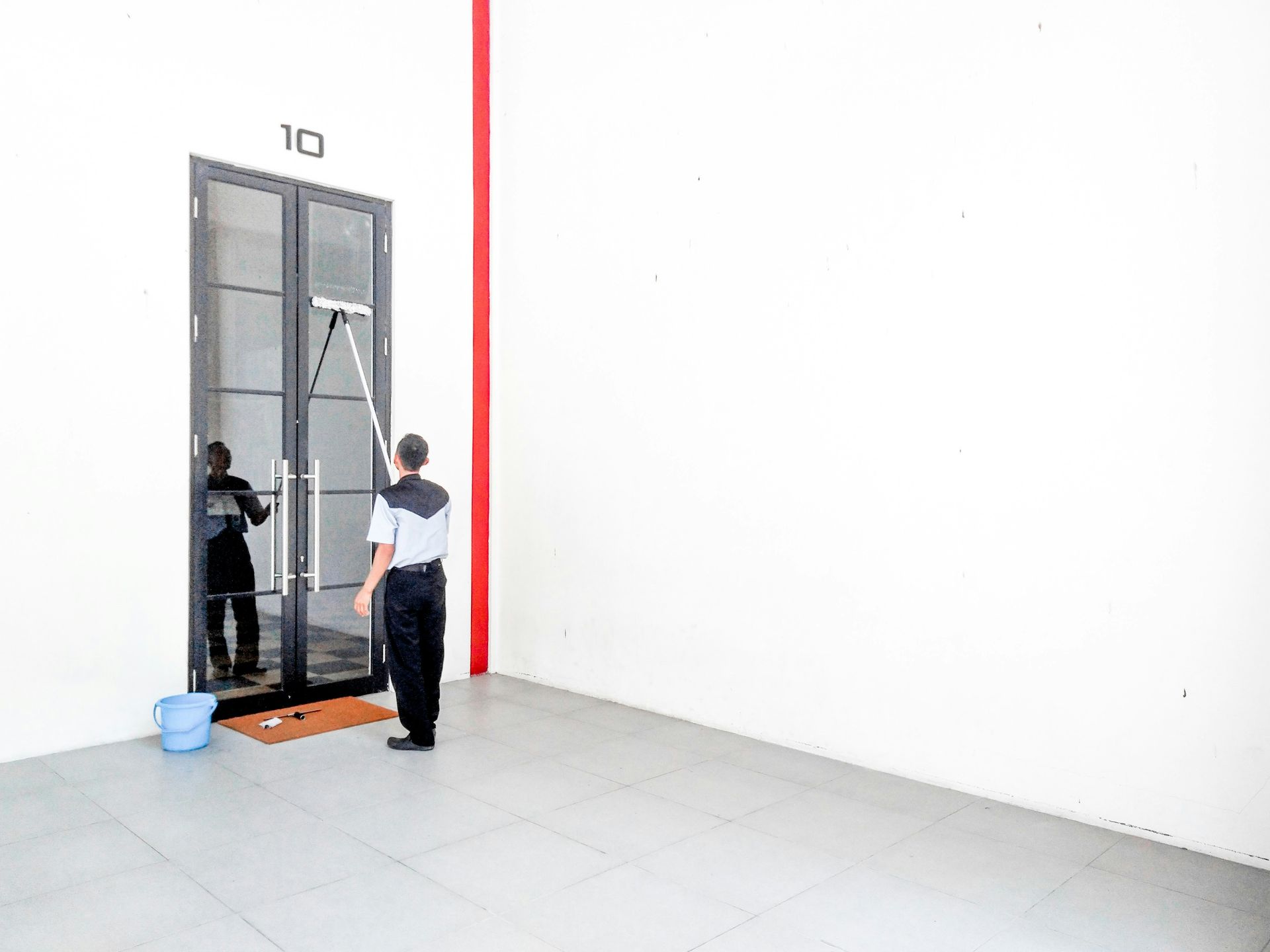 a man standing in front of a glass door